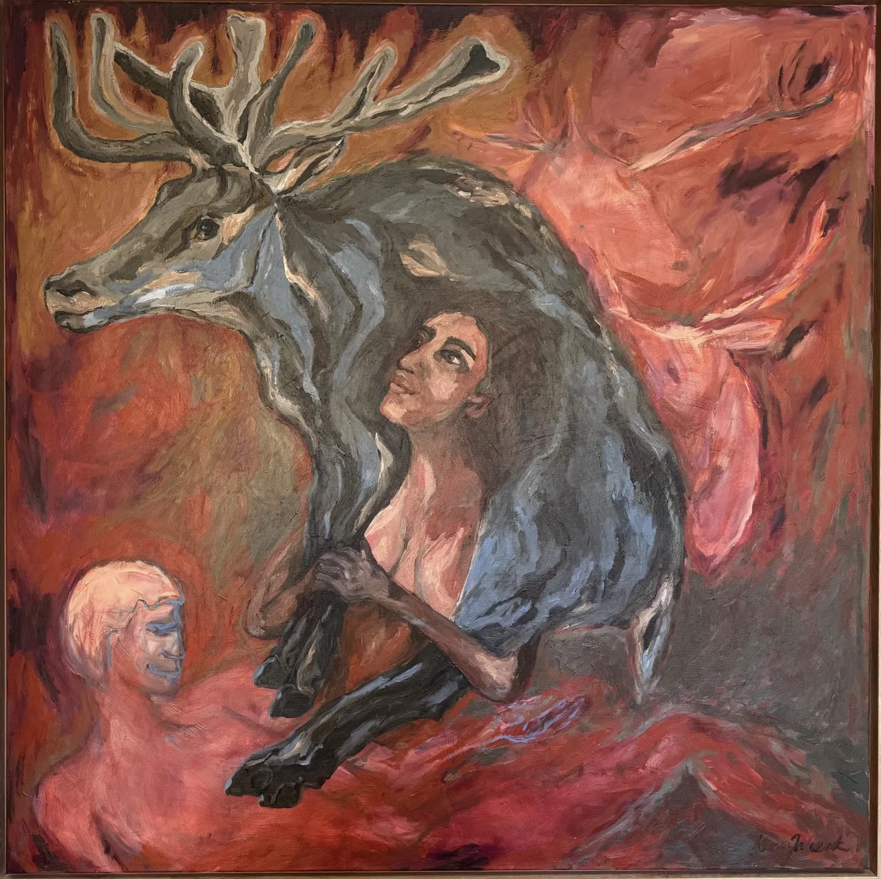 A woman seated beneath branching antlers