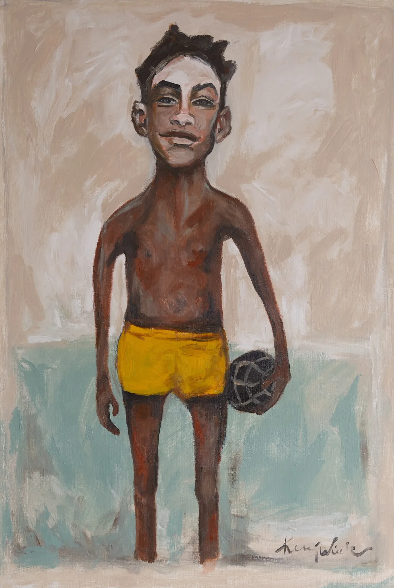 Boy wearing yellow shorts standing against a pale ground